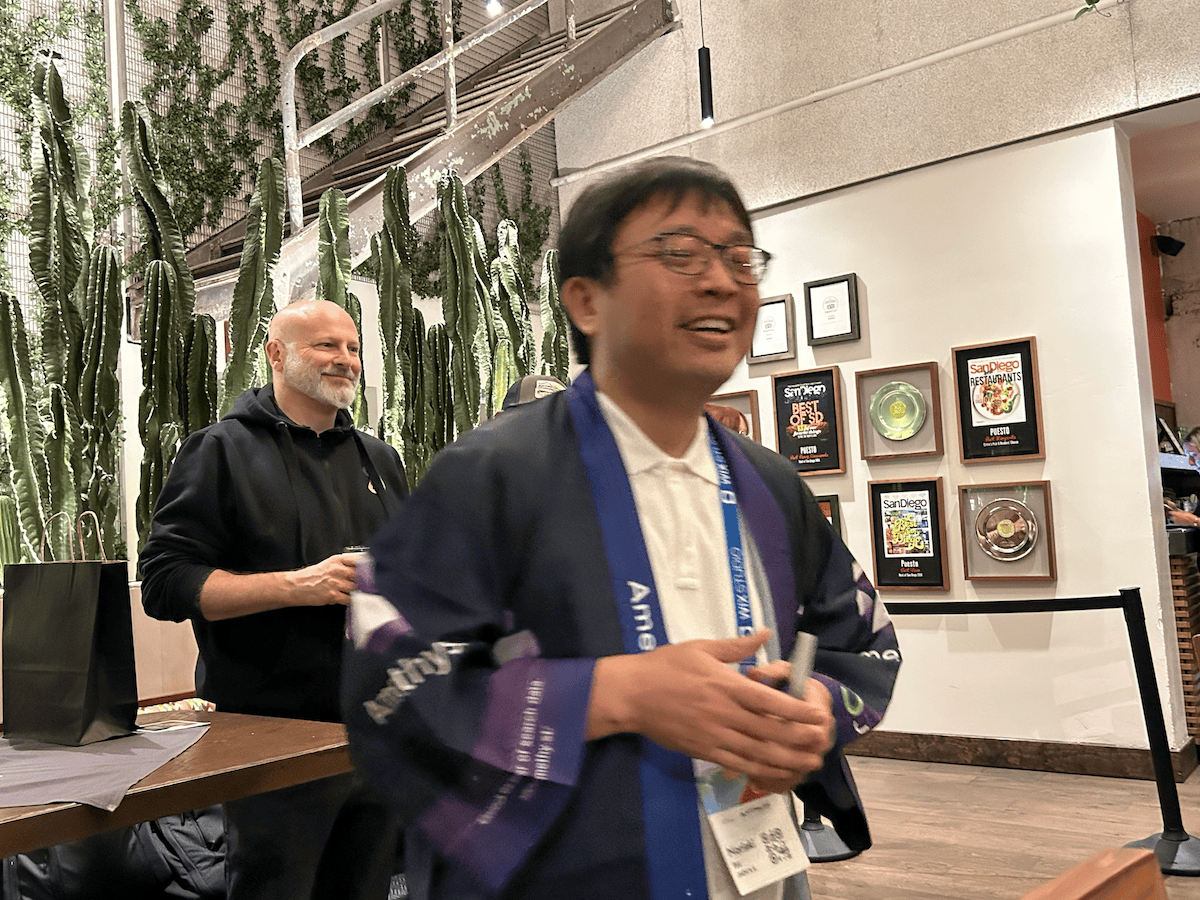 Nori from Amethyst and Ray from Demandsphere greet guests at SEO dinner at Puesta