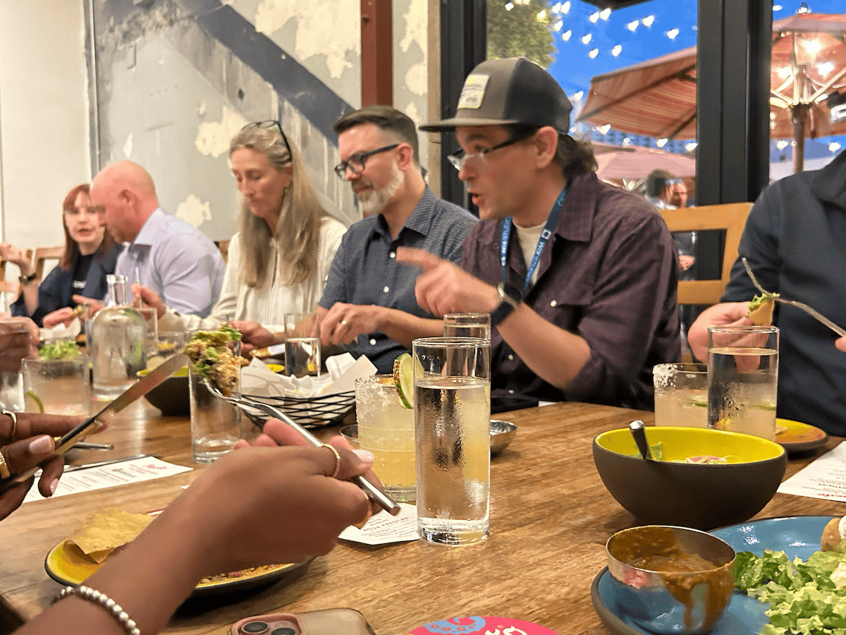 Overhead shot of the dinner table full of guests and tacos